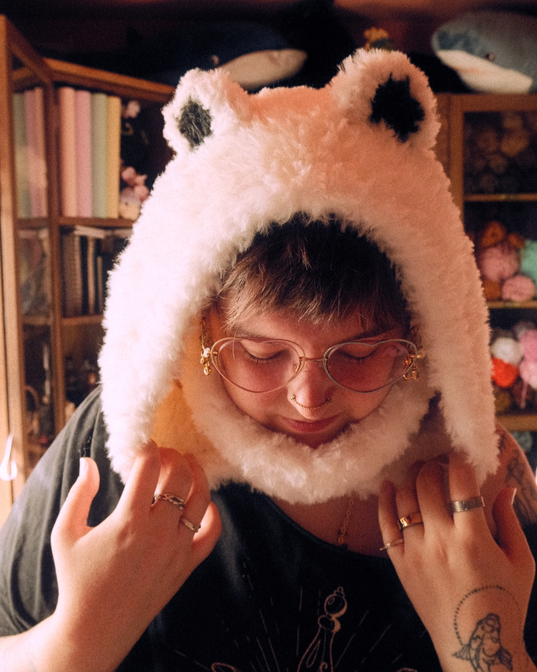 Person wearing a white fur hood with bear ears