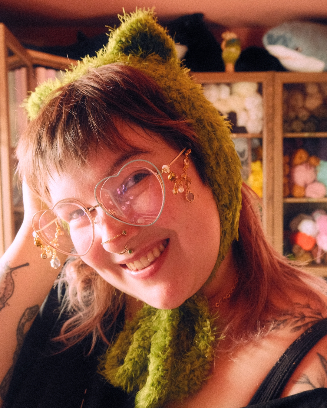 Person wearing headband style earmuff made of mossy yarn with cat ears