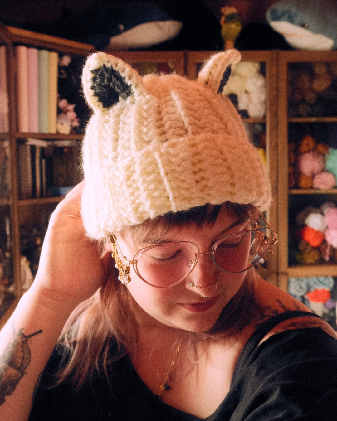 Person wearing a crochet beanie hat with animal ears