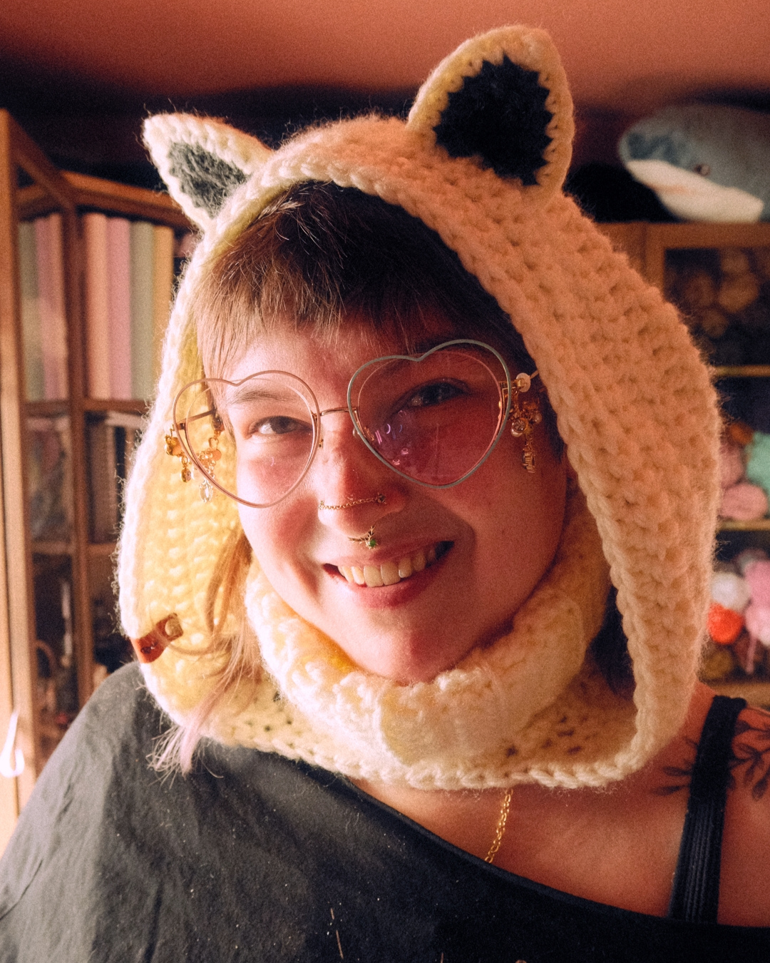 Person wearing a knitted animal hood with ears indoors