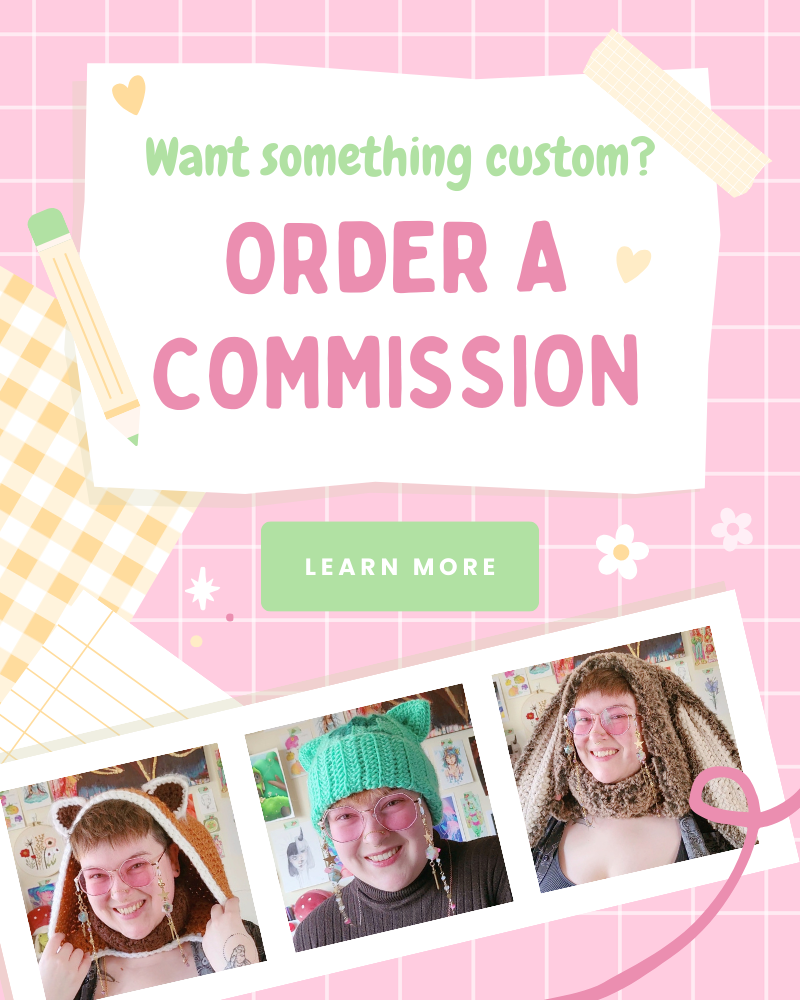 Banner that reads "Want something custom? Order a commission!" With a green button that reads "Learn more". There are three photos: Rayn wearing a brown, furry, bunny ear hood, Rayn wearing a teal bulbasaur themed beanie, Rayn wearing a red panda themed hood.